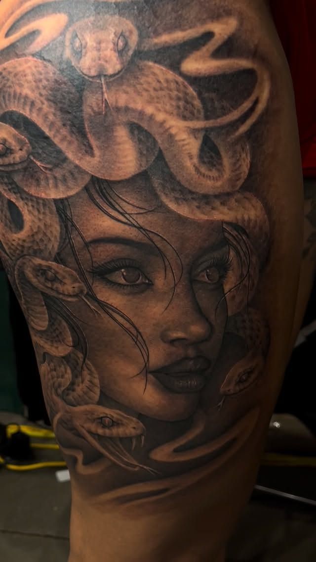 Black and grey Medusa with snakes on an arm