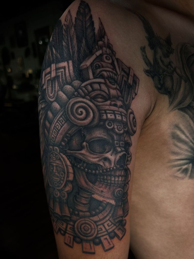 Black and grey Aztec-style skull on a shoulder