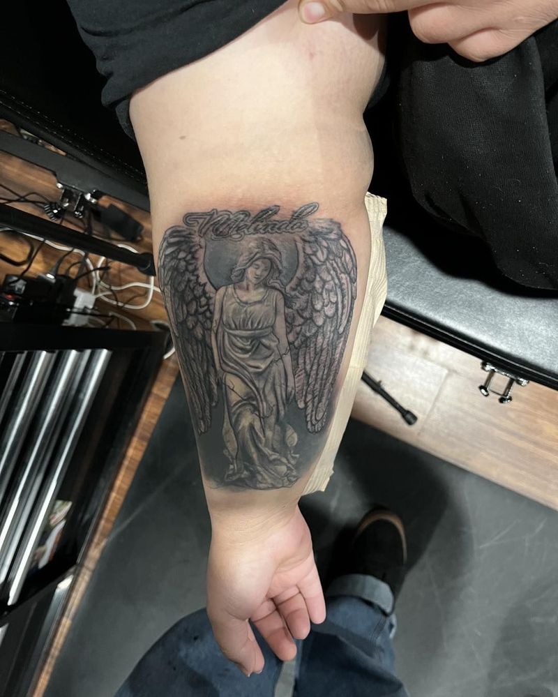 Black and grey angel on a forearm