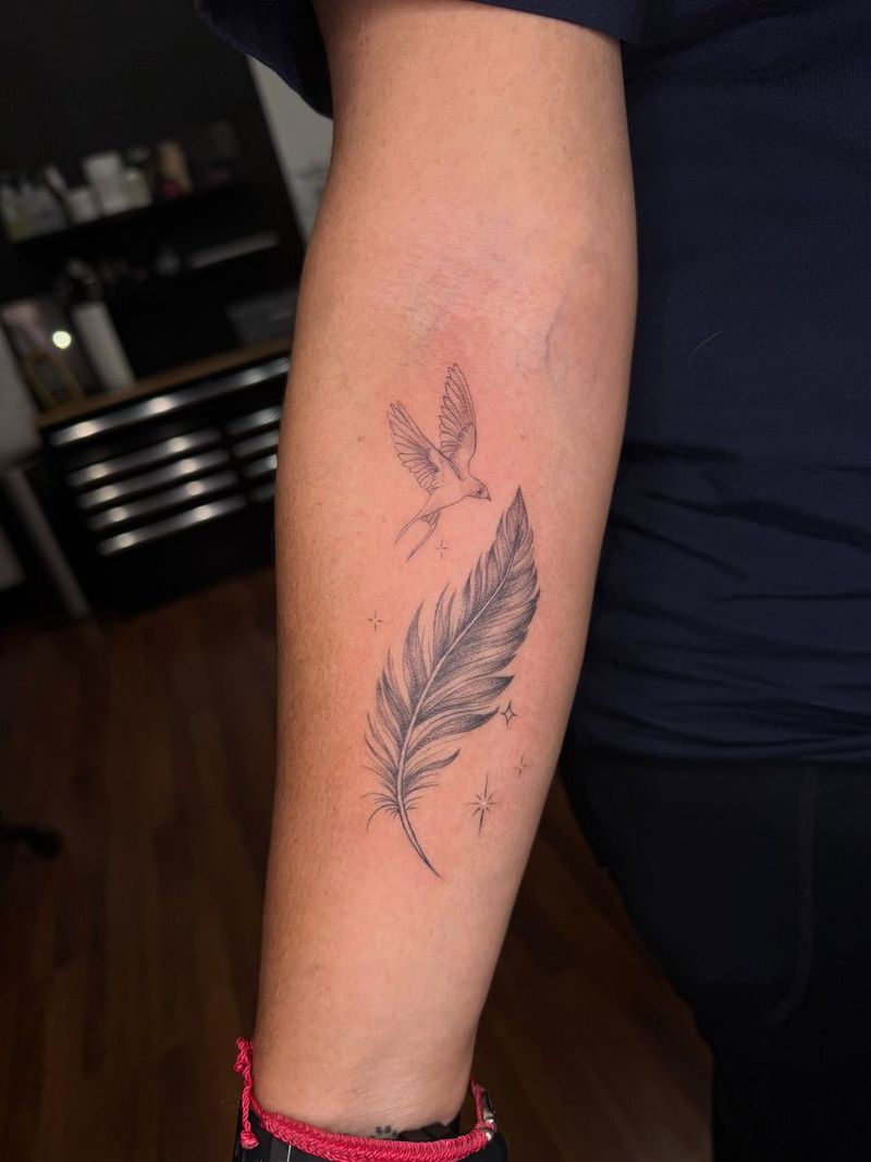 Fine line feather and bird on a forearm